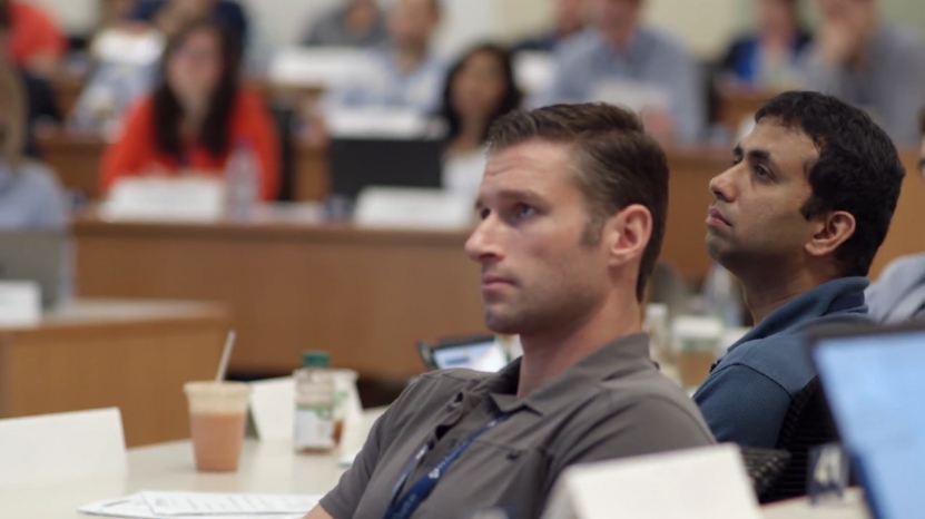 Business professionals attending an EMBA class with focused attention