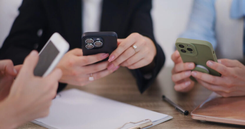 Three employees with their iPhones