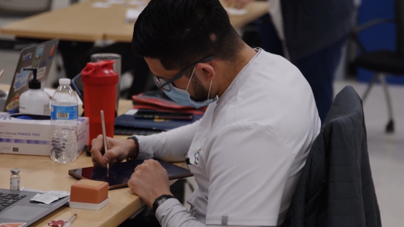 A Healthcare Worker Using a Tablet to Improve Patient Care