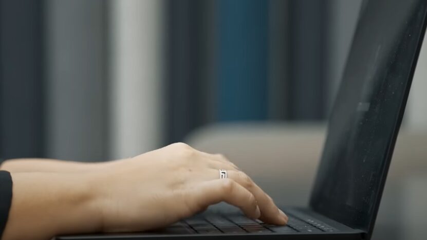 Woman typing on a laptop keyboard