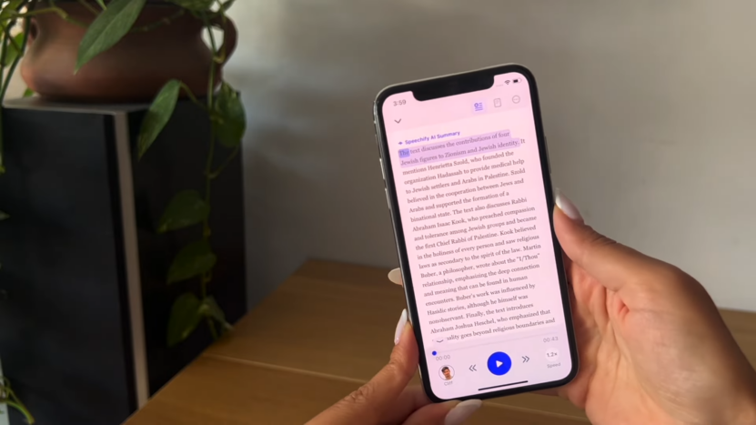 A Person Holding a Phone, Using the Speechify App to Listen to Text Being Read Aloud