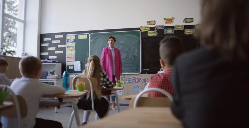 A teacher is giving a lesson to the children