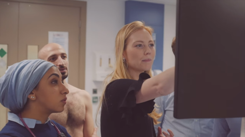 A Group of Medical Professionals Discussing a Patient's Case in A Hospital Setting